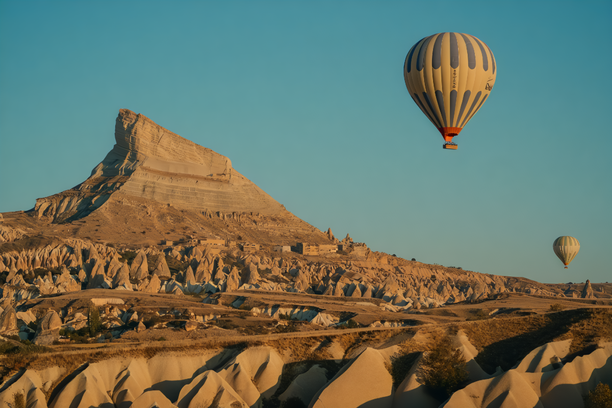 Two hot air balloons floating above the iconic rock formations of Cappadocia, Turkey