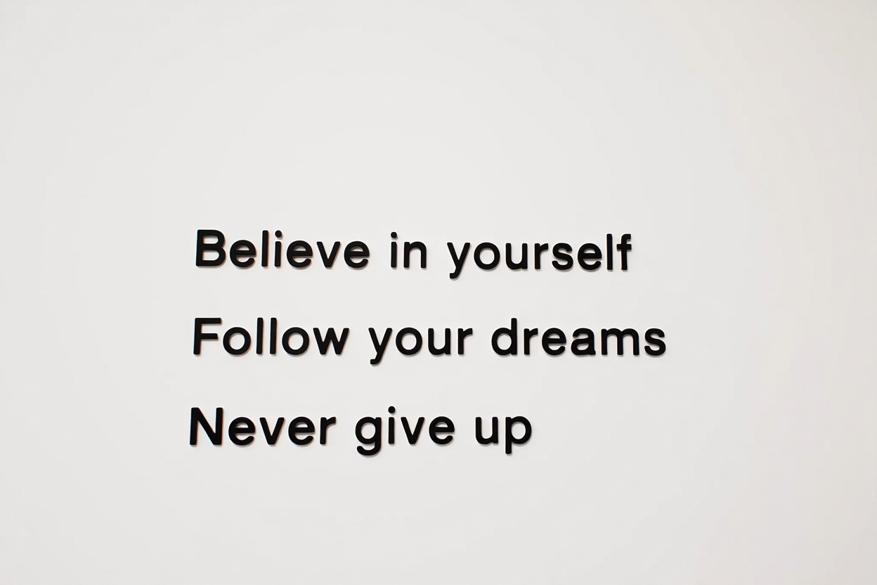 A white wall features black lettering displaying three inspirational quotes in clean, legible font